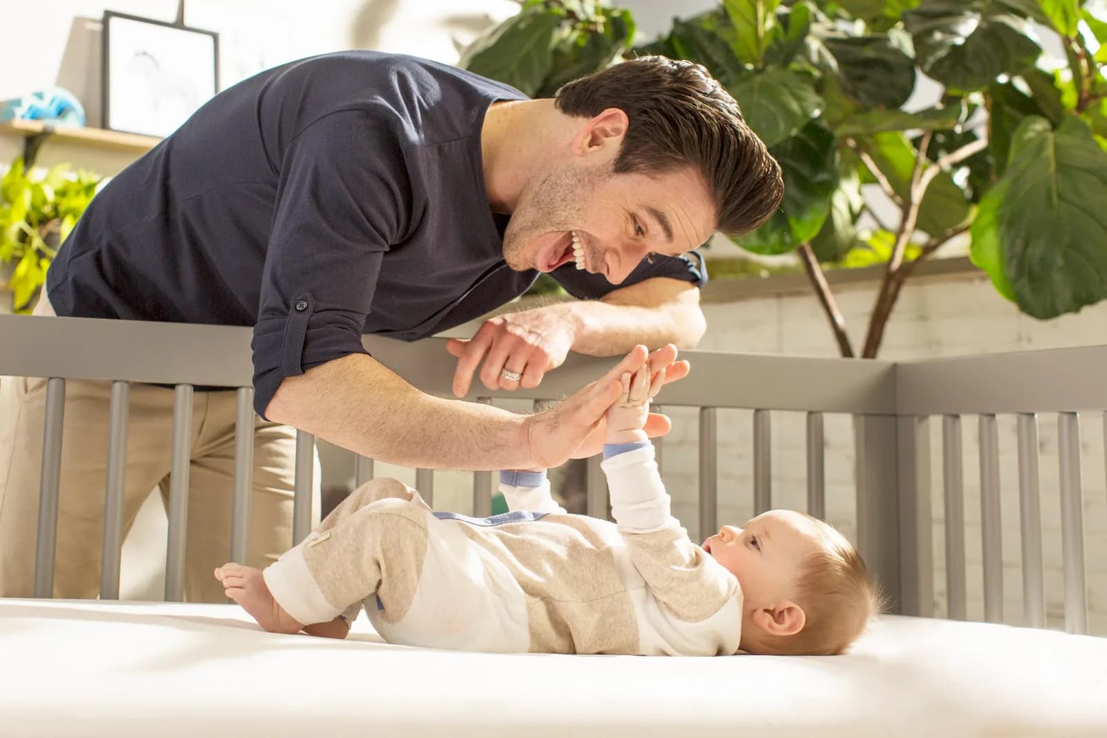 A parent and baby together on a Naturepedic Breathe Safe crib mattress