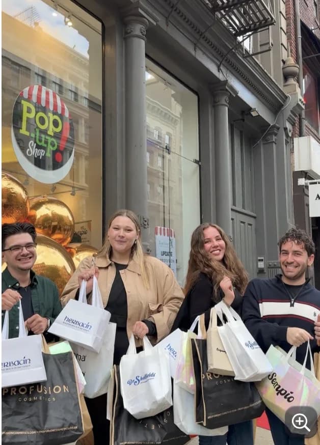 Attendees outside the Herbacin SoHo pop-up shop with branded bags